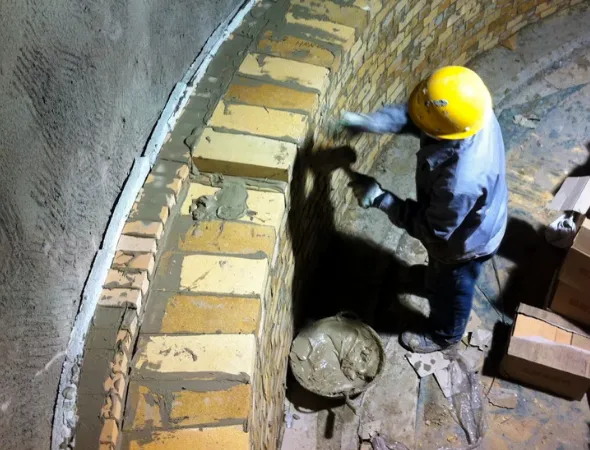 Workers are using refractory mortar to repair the kiln