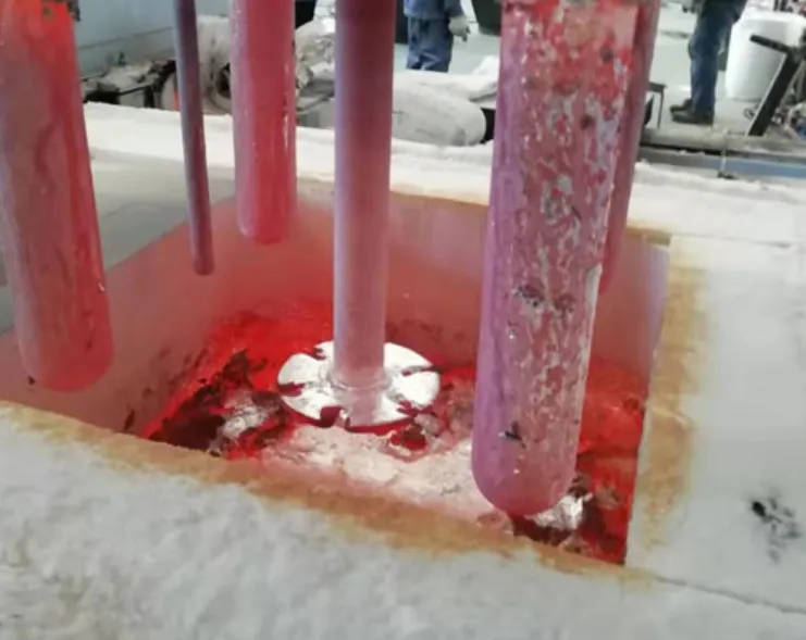 AdTech graphite rotor lifted from molten aluminum during degassing process