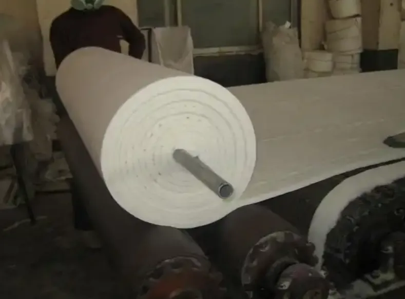 Industrial machine rolling ceramic fiber blanket into rolls for high temperature insulation